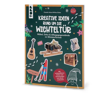 Das Buch »Kreative Ideen rund um die Wichteltür« zeigt auf dem Cover Miniaturen von Möbeln und Dekorationen auf grünem Hintergrund.