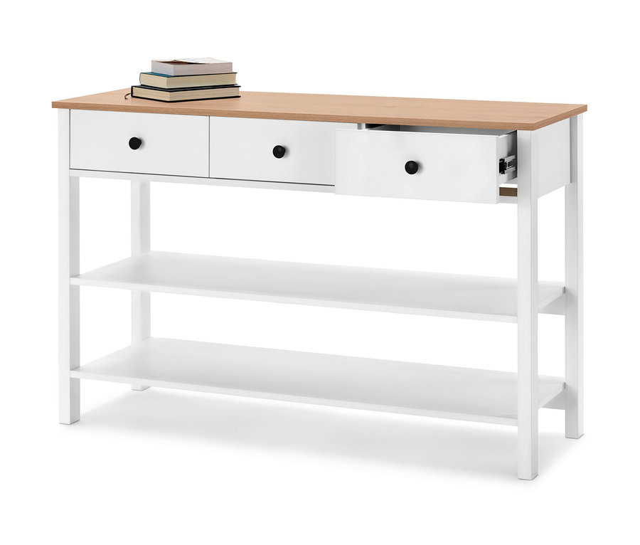 Eine Anrichte mit Schubladen in Weiß und hellem Holz. Auf der Anrichte liegen Bücher.