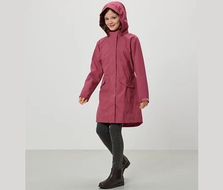 Lächelndes Mädchen trägt einen Kinder-Regenparka.