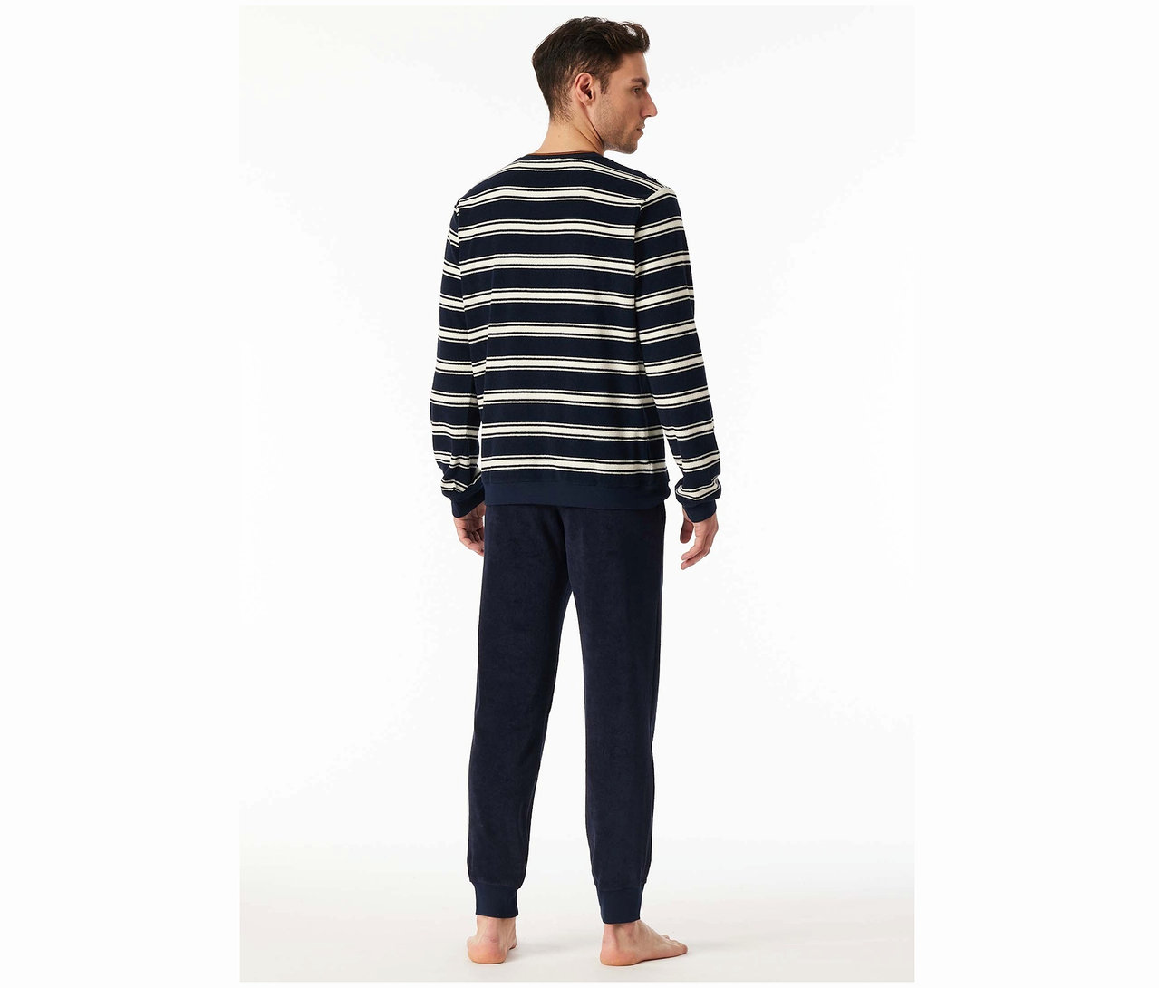 Mann von hinten mit einem gestreiften Oberteil und dunkelblauer Hose.
