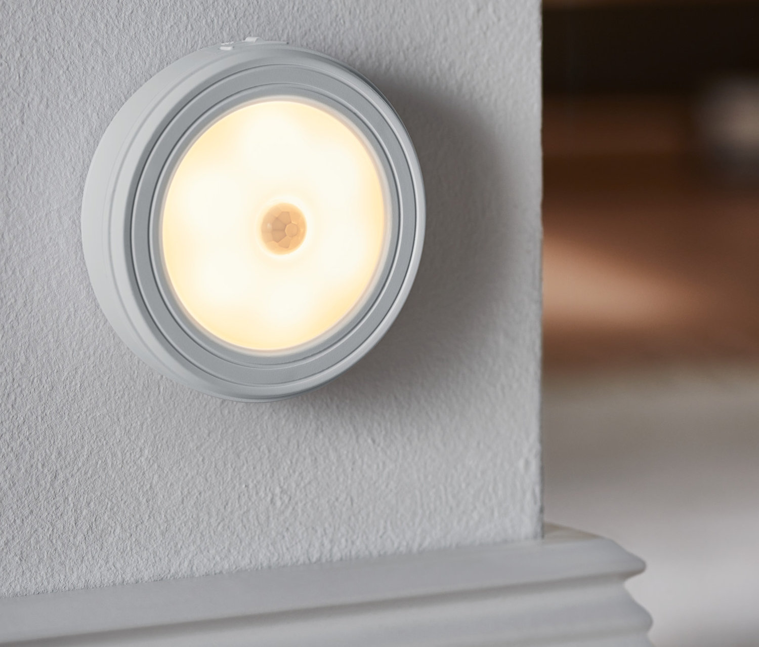 Eine LED-Multifunktionsleuchte ist an einer Wand befestigt.