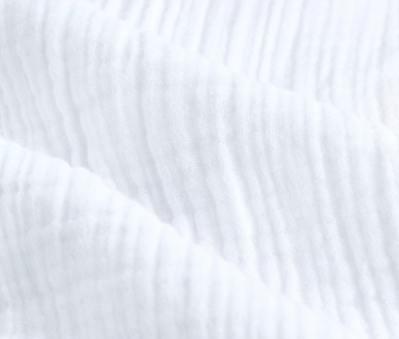 Nahaufnahme der weißen Musselin-Bettwäsche in Standardgröße.