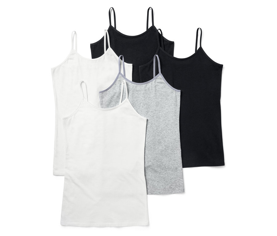 Fünf Tanktops in Weiß, Grau und Schwarz. Die Tanktops haben dünne Träger.