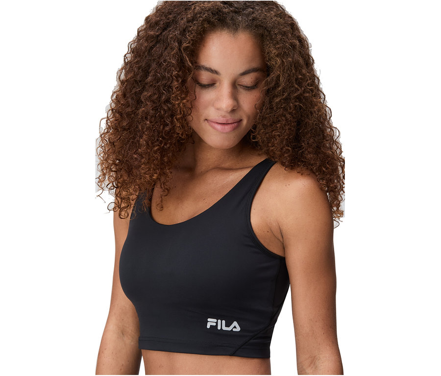Frau mit lockigem braunem Haar trägt ein schwarzes FILA Damen-Sport-Bralette und blickt nach unten.