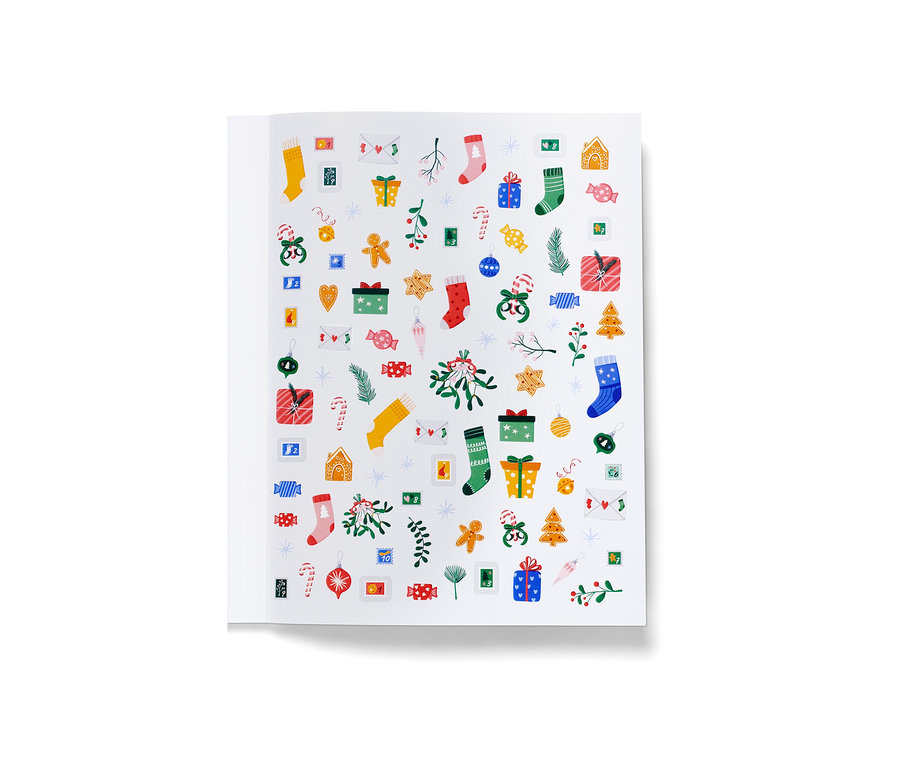 Aufgeschlagenes Buch mit Weihnachtsaufklebern.