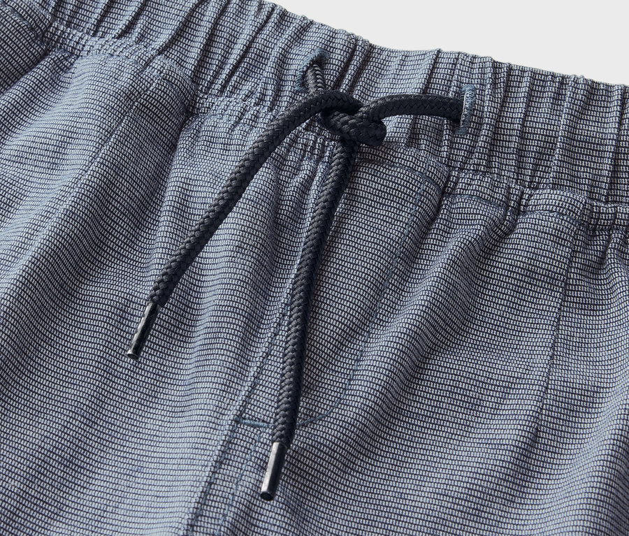 Detailaufnahme von blau gestreiften Shorts mit elastischem Bund und Kordelzug.