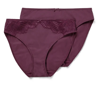 Zwei bordeauxrote Slips, einer mit Spitze, liegen übereinander.