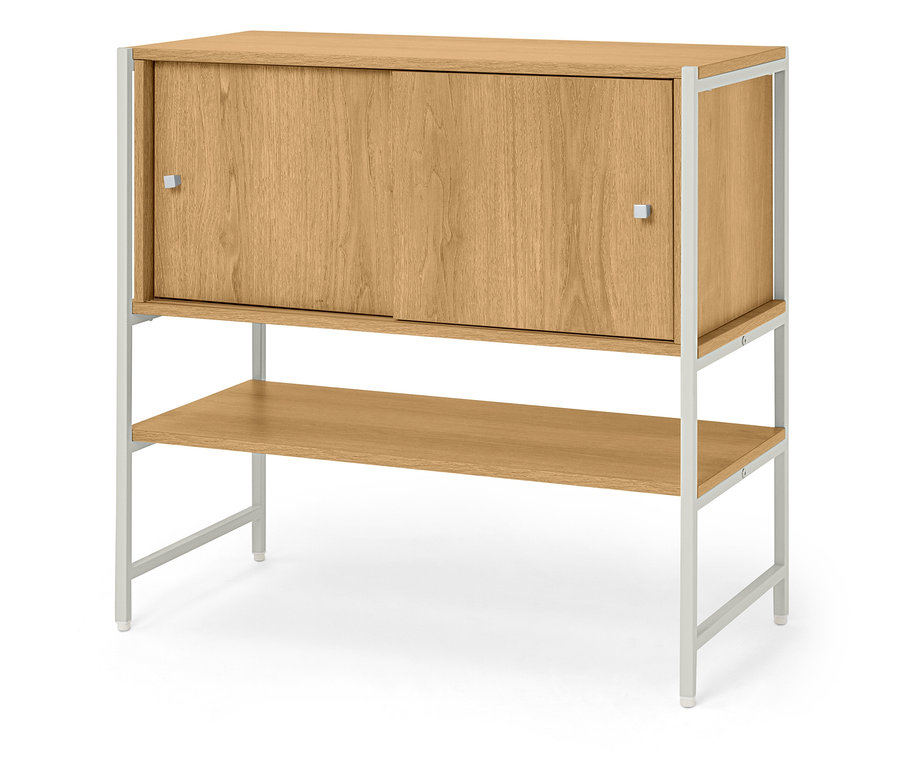 Ein Holzschrank mit Schiebetüren und einem Regal steht auf einem weißen Metallgestell.