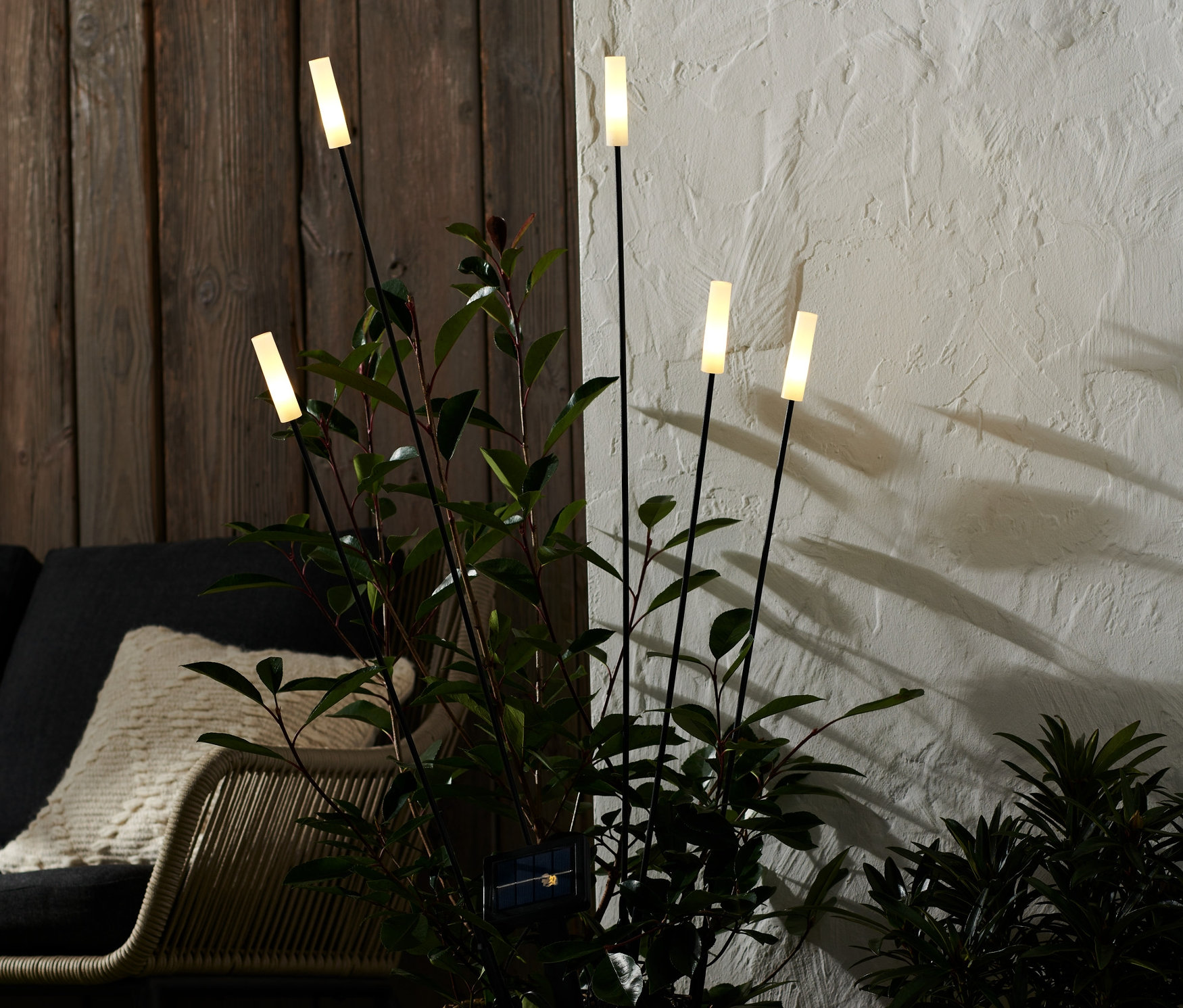 Ein Weidenkorb mit Pflanze und 5 Solar-Leuchtspießen.