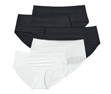 Auf dem Bild sind fünf Magic-Cut-Pantys, weiß und schwarz, übereinander angeordnet.
