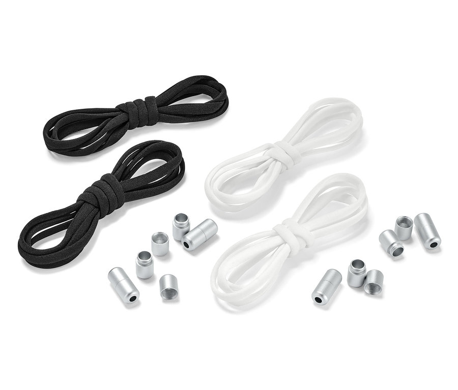 Zwei Paar elastische Schnürsenkel, ein Paar schwarz und ein Paar weiß, liegen nebeneinander mit Metallenden.