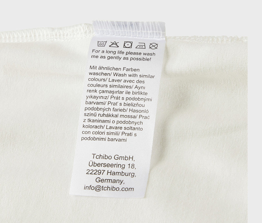 Pflegehinweisetikett von 5 Baby-Bodys mit Mitwachsfunktion.