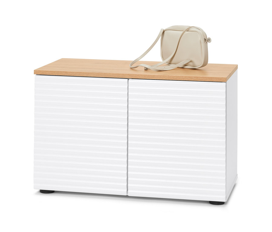 Eine Sitzbank mit Stauraum, weißen Türen und einer hölzernen Oberseite. Auf der Oberseite liegt eine cremefarbene Handtasche.