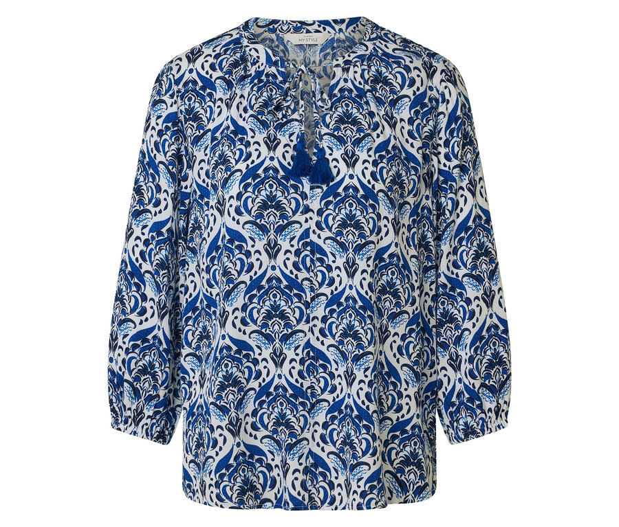 Bluse mit blau-weißem Muster und Troddel-Detail.