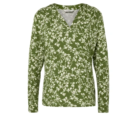 Grüne, langärmlige Bluse mit weißem Blumenmuster.