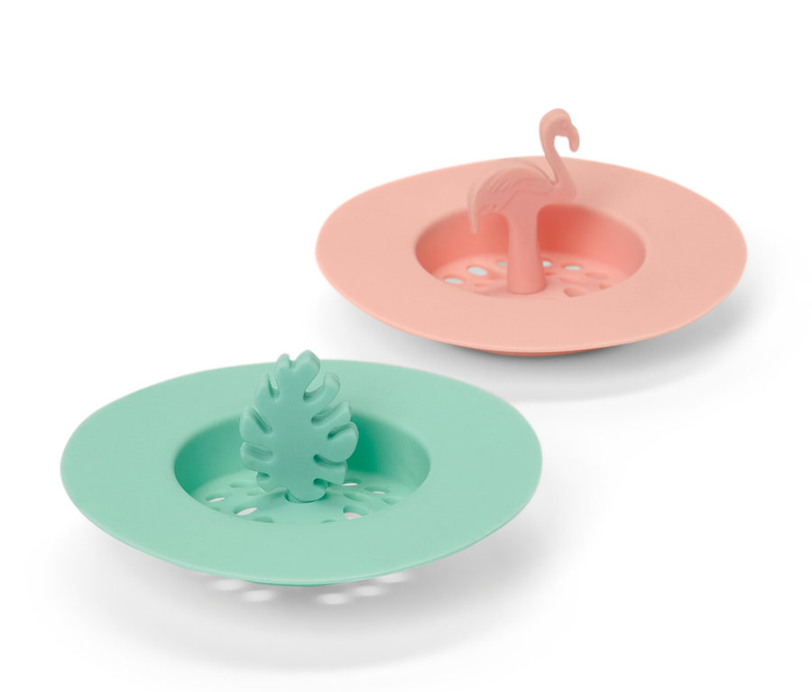 Zwei Abflusssiebe aus Silikon: eins in Pfirsichfarbe mit Flamingo, eins in Grün mit Blatt.