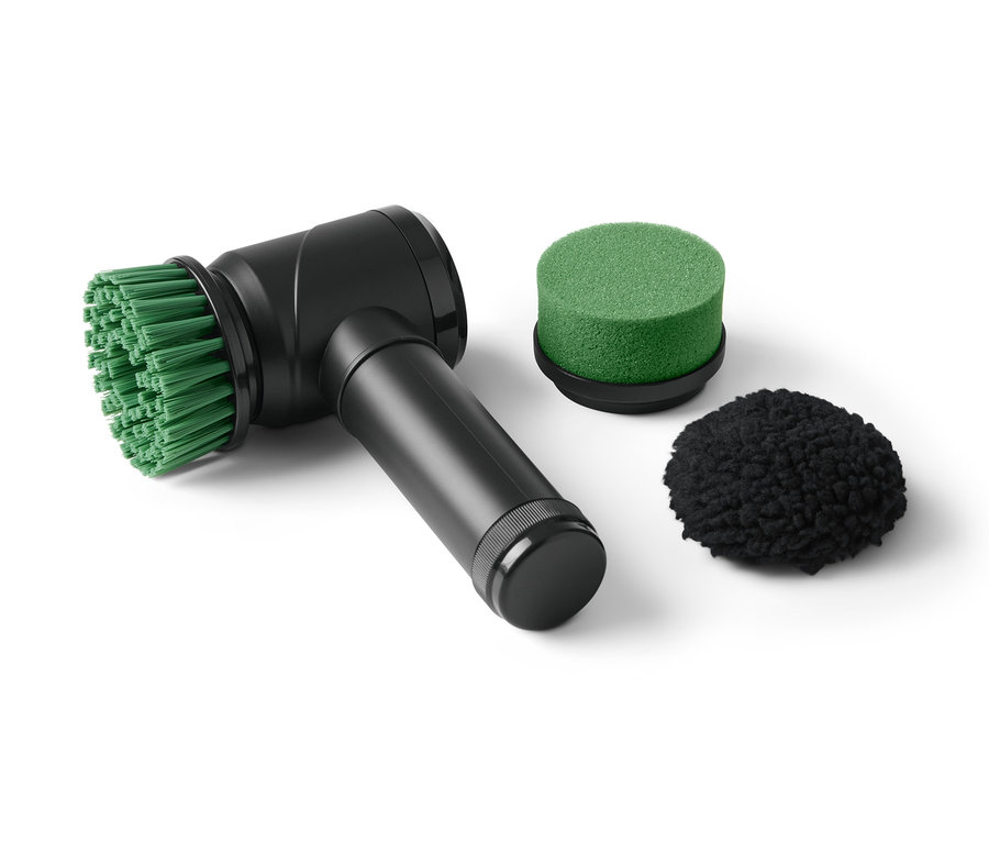 Eine schwarze elektrische Reinigungsbürste mit grünem und schwarzem Aufsatz.