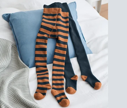 Auf einem Bett liegen zwei blaue Thermo-Strumpfhosen.
