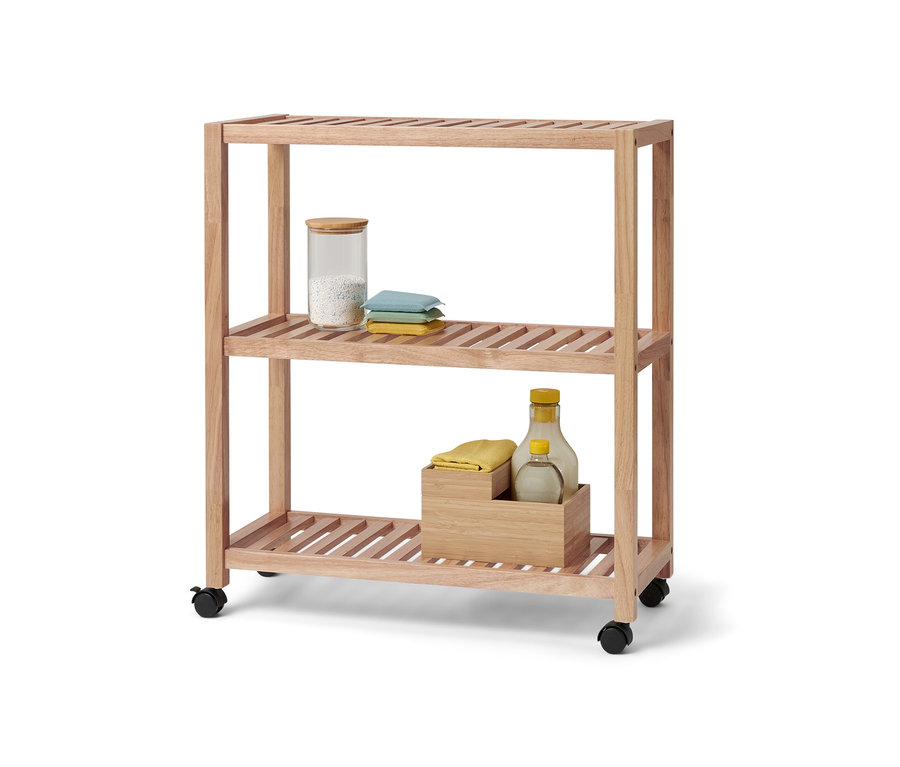 Ein dreistöckiges Massivholzregal mit Rollen. Im obersten Fach befinden sich ein Glasbehälter und Textilien.