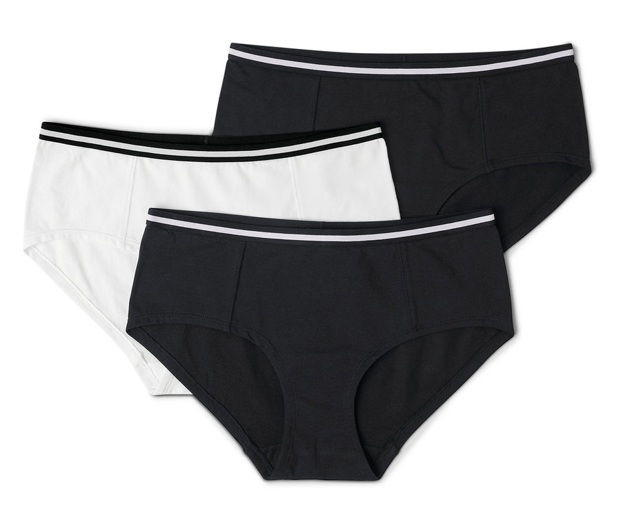 Drei Damen Slips, einer in Weiß und zwei in Schwarz, alle mit einem weißen Bund, liegen übereinander.