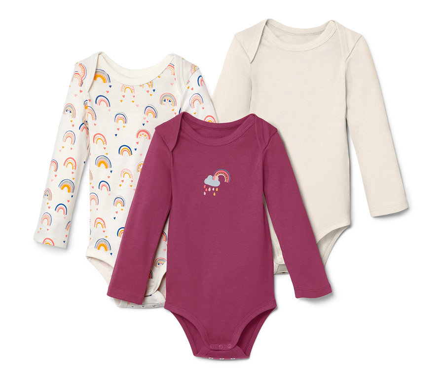 Drei Langarmbodys mit Regenbogenmotiven.