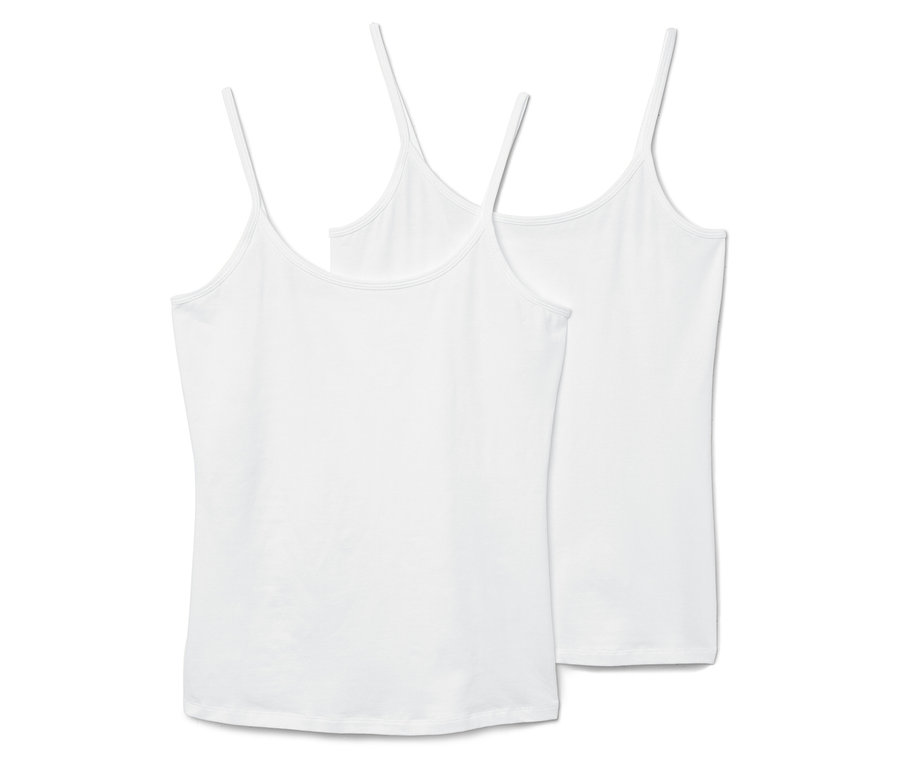 Zwei weiße Tanktops mit dünnen Trägern liegen nebeneinander.