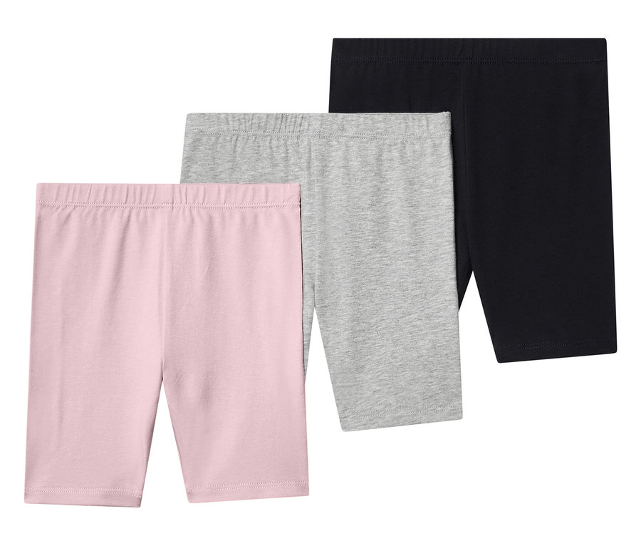 Drei kurze Leggings in Rosa, Grau und Schwarz liegen übereinander.