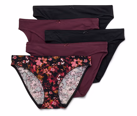 Fünf Baumwollslips in Schwarz, Burgunder und mit Blumenmuster liegen übereinander.