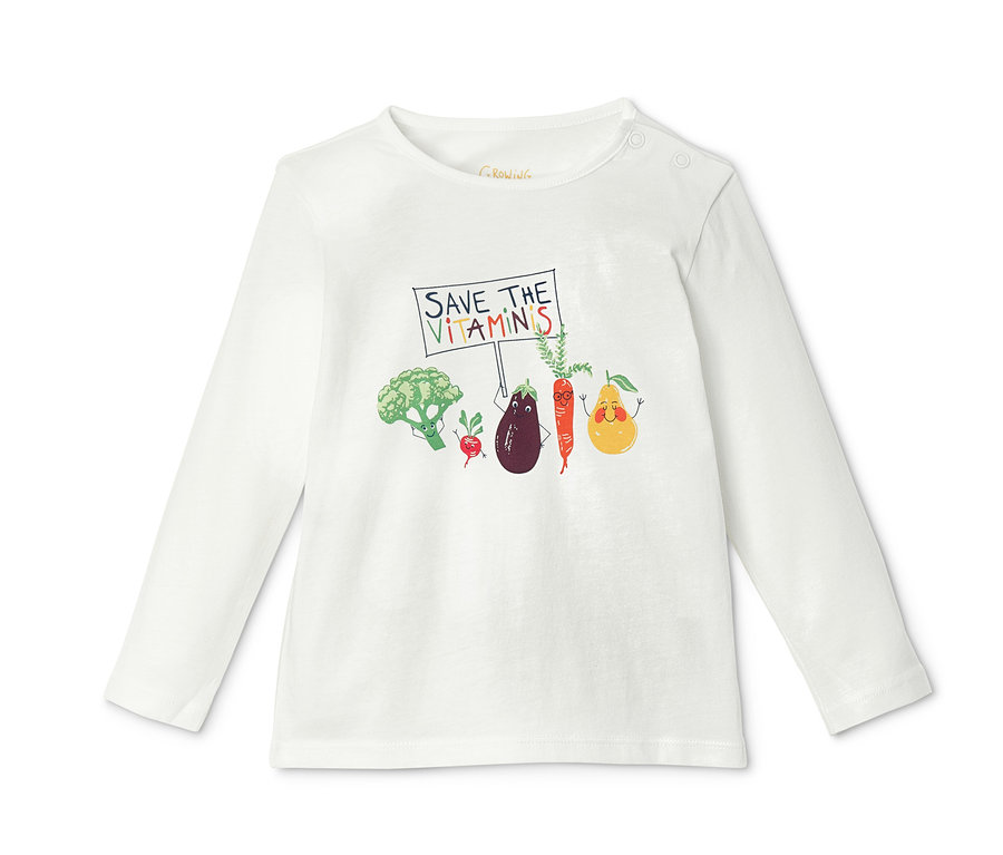 Weißes Langarmshirt mit Gemüse-Print, das ein Schild mit der Aufschrift „Save the Vitamins“ hält.
