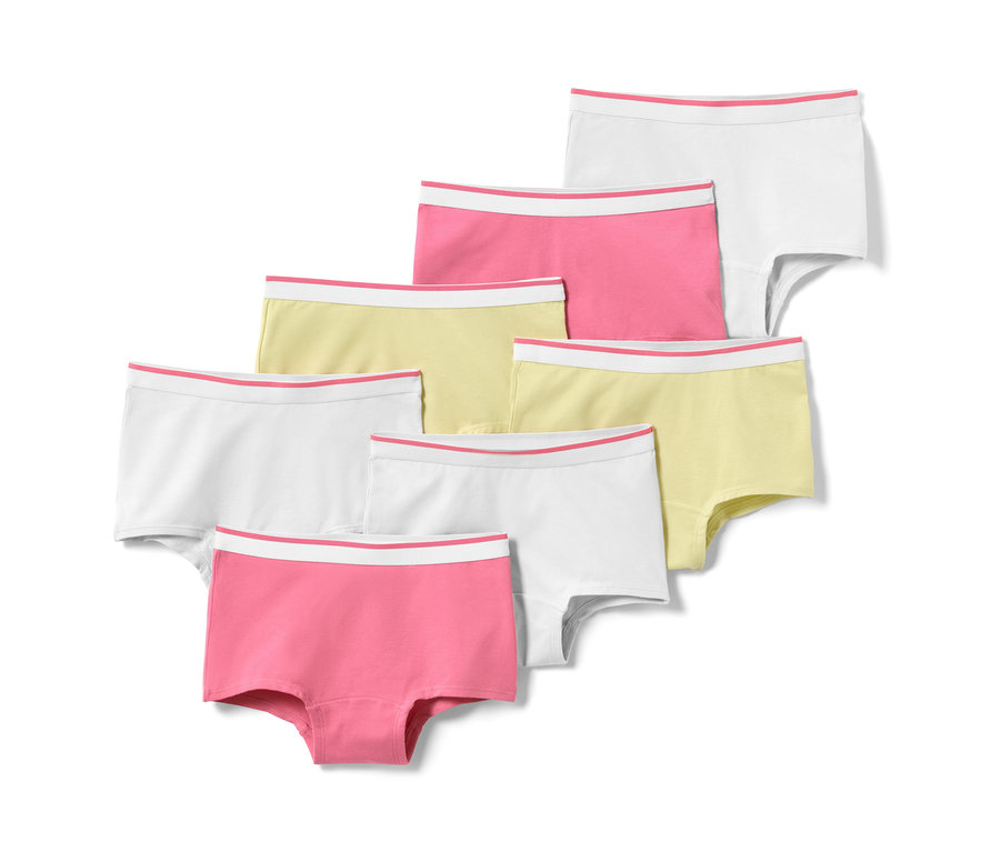 Sieben Mädchen-Pantys in Rosa, Gelb und Weiß.