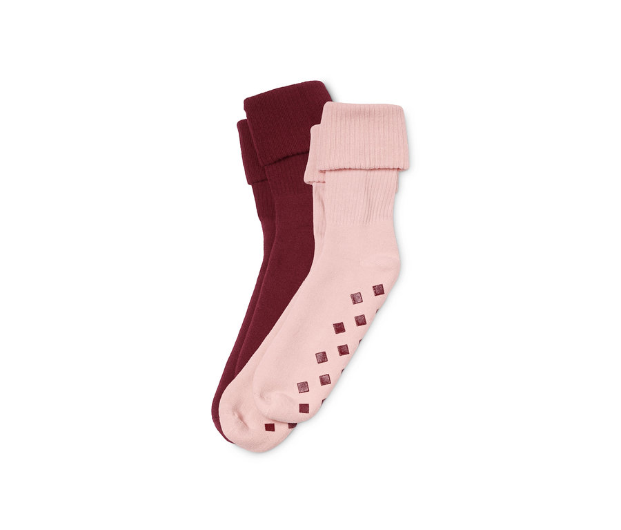 Zwei Paar Stoppersocken: ein Paar in Burgunderrot, ein Paar in Rosa.
