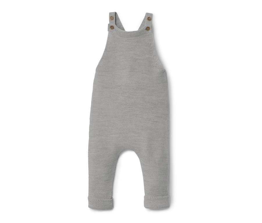 Eine graue Baby-Merino-Latzhose liegt auf einem weißen Hintergrund.