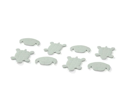 Acht hellgrüne Antirutsch-Pads in Form von Krabben und Schildkröten.