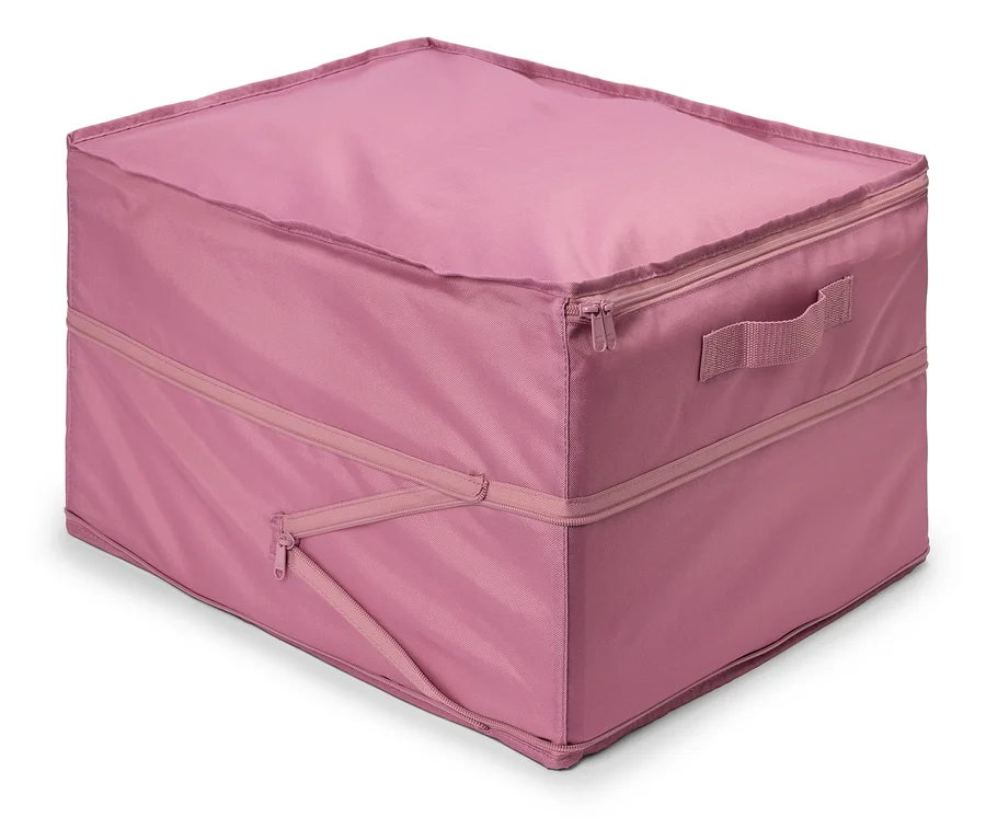 Ein rosa Stoffbehälter mit Reißverschluss und Griff liegt auf dem Boden.