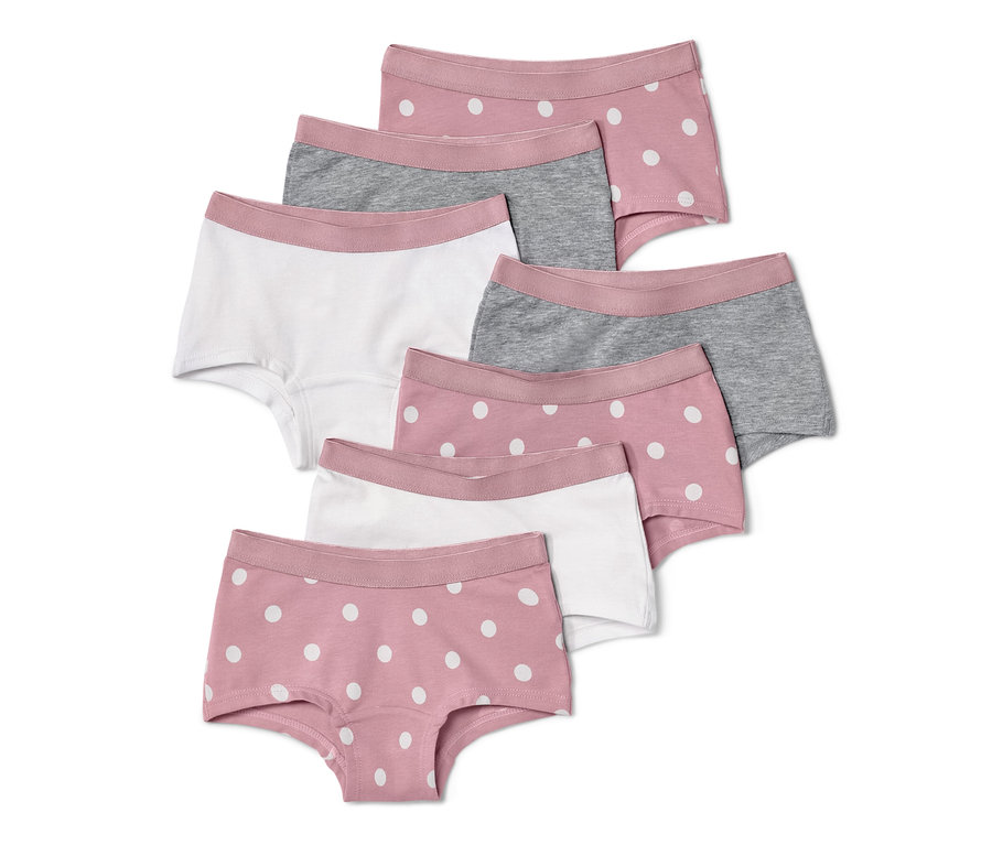 Sieben Mädchen-Pantys: zwei rosa mit weißen Punkten, zwei grau und drei weiß.