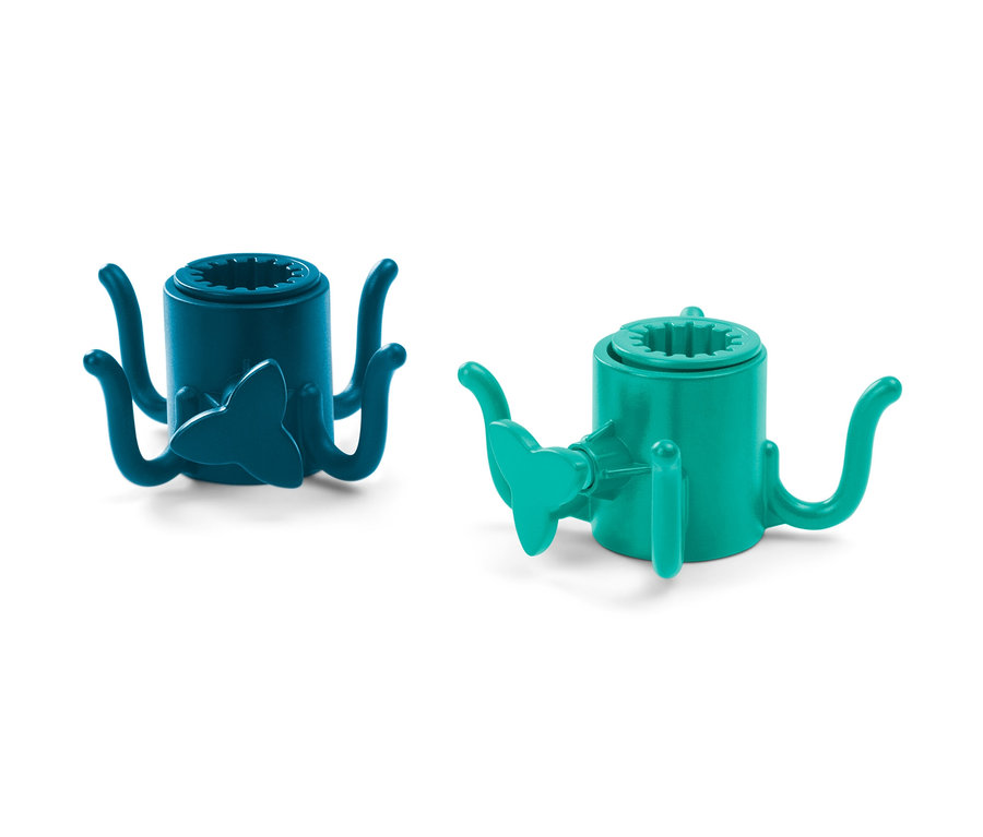 Zwei Sonnenschirm-Haken, einer blau, einer grün, liegen auf einem weißen Hintergrund.