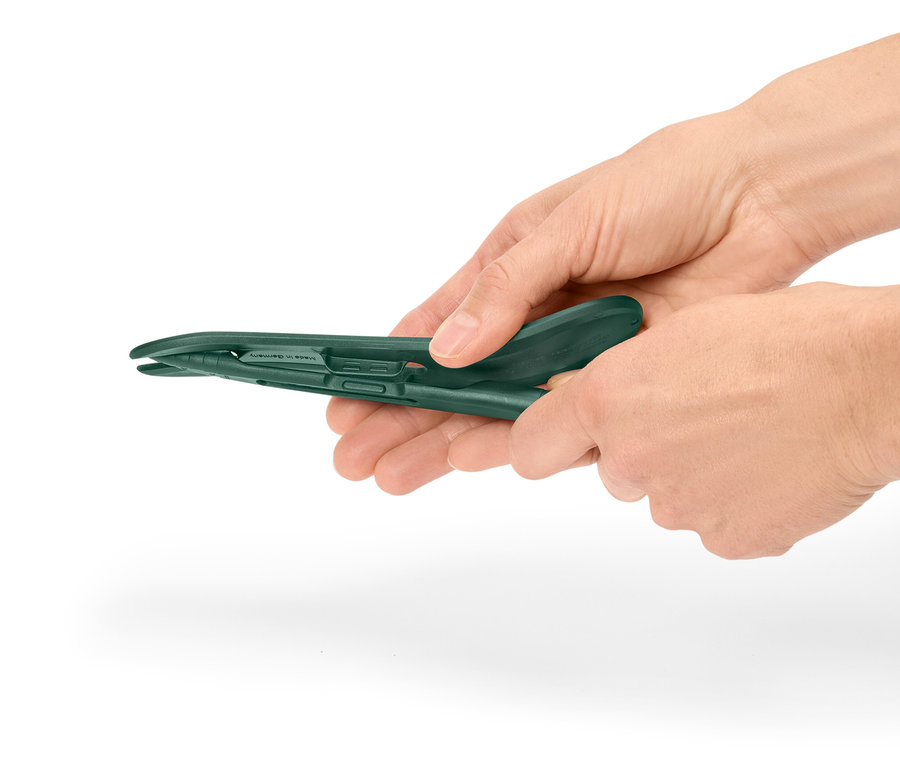 Hände halten eine grüne Kunststoffzange.