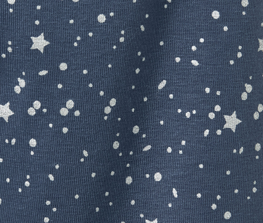 Detailaufnahme von 2 Kinder-Glitzer-Leggings mit Stern- und Punktmuster.