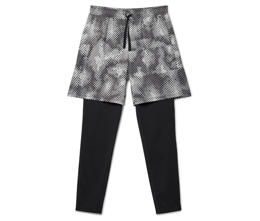 Schwarze Leggings mit darüberliegenden Shorts mit Punktmuster.