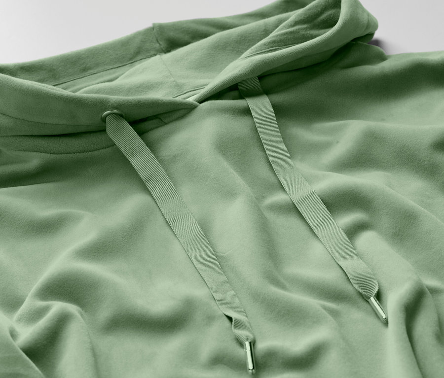 Detailansicht eines hellgrünen Hoodies mit Kordelzug.