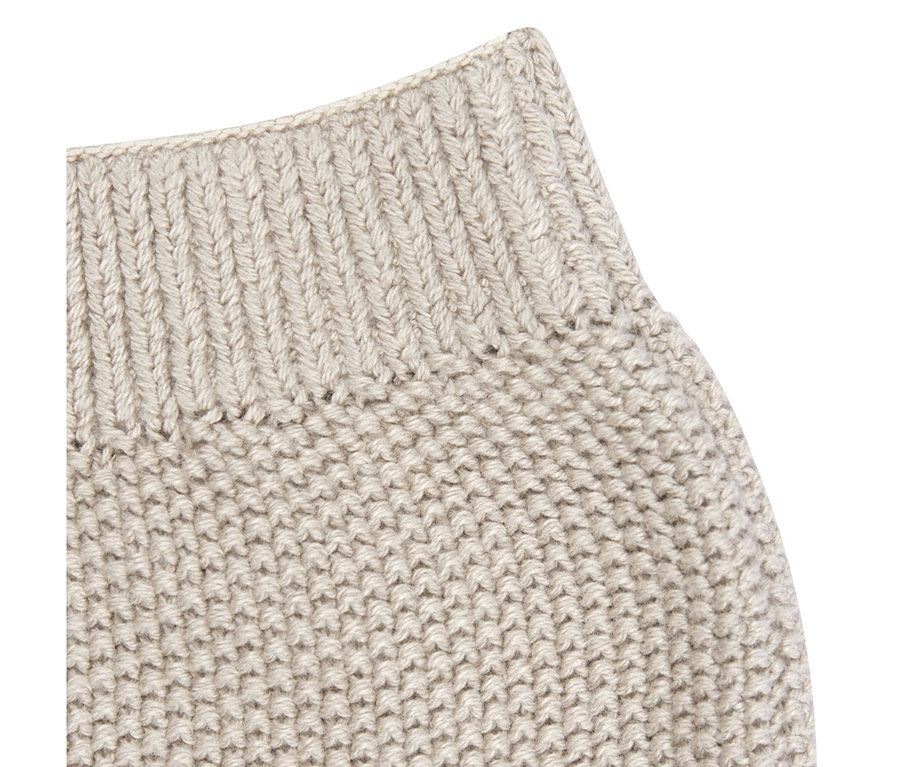 Nahaufnahme einer hellbeigen Sterntaler Baby-Strickhose mit geripptem Bund und strukturiertem Strickmuster.