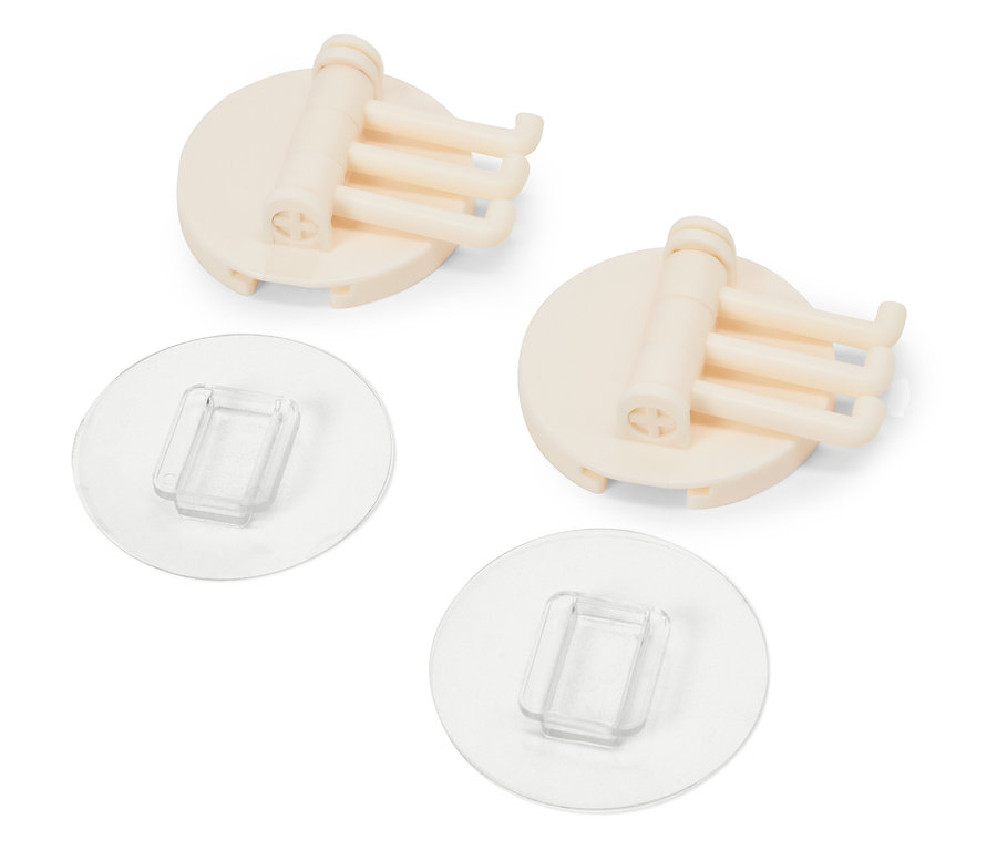 Zwei beige Halterungen mit je drei Haken und transparenten Klebepads.