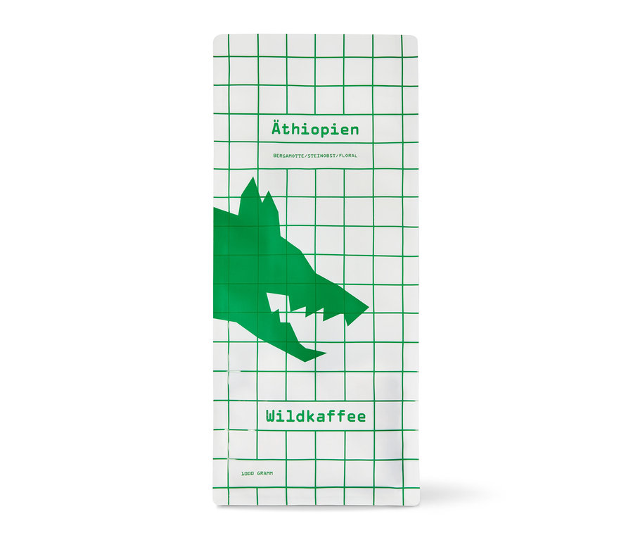 Weiße Packung Wildkaffee - Äthiopien West Arsi Omni-Roast mit grünem Gittermuster und Wolfskopf. 1 kg Ganze Bohne.