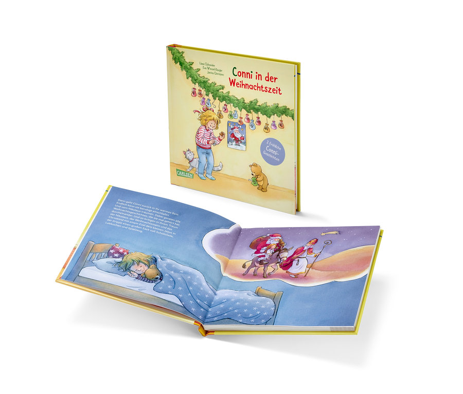 Ein offenes Buch zeigt ein Mädchen, das im Bett schläft und von Nikolaus und Santa träumt.