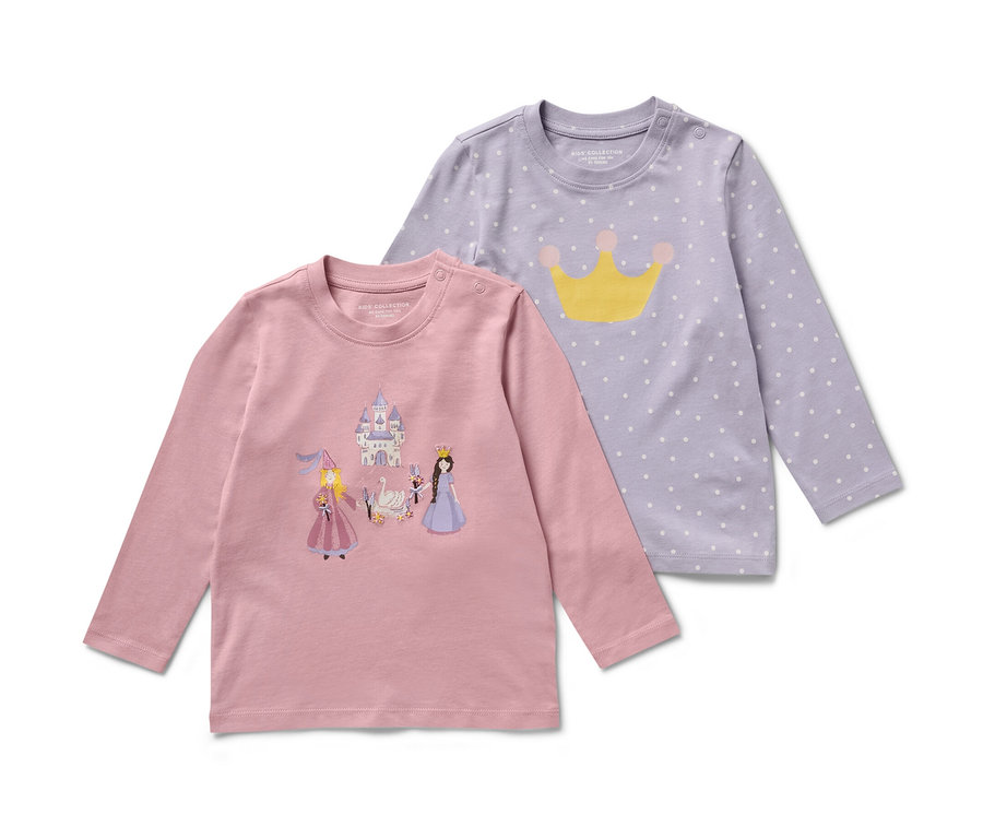 Zwei Kinder-Langarmshirts, Prinzessin Motiv. Eines ist rosa mit Schloss- und Prinzessinnenbildern, das andere lila mit weißen Punkten und einer gelben Krone.