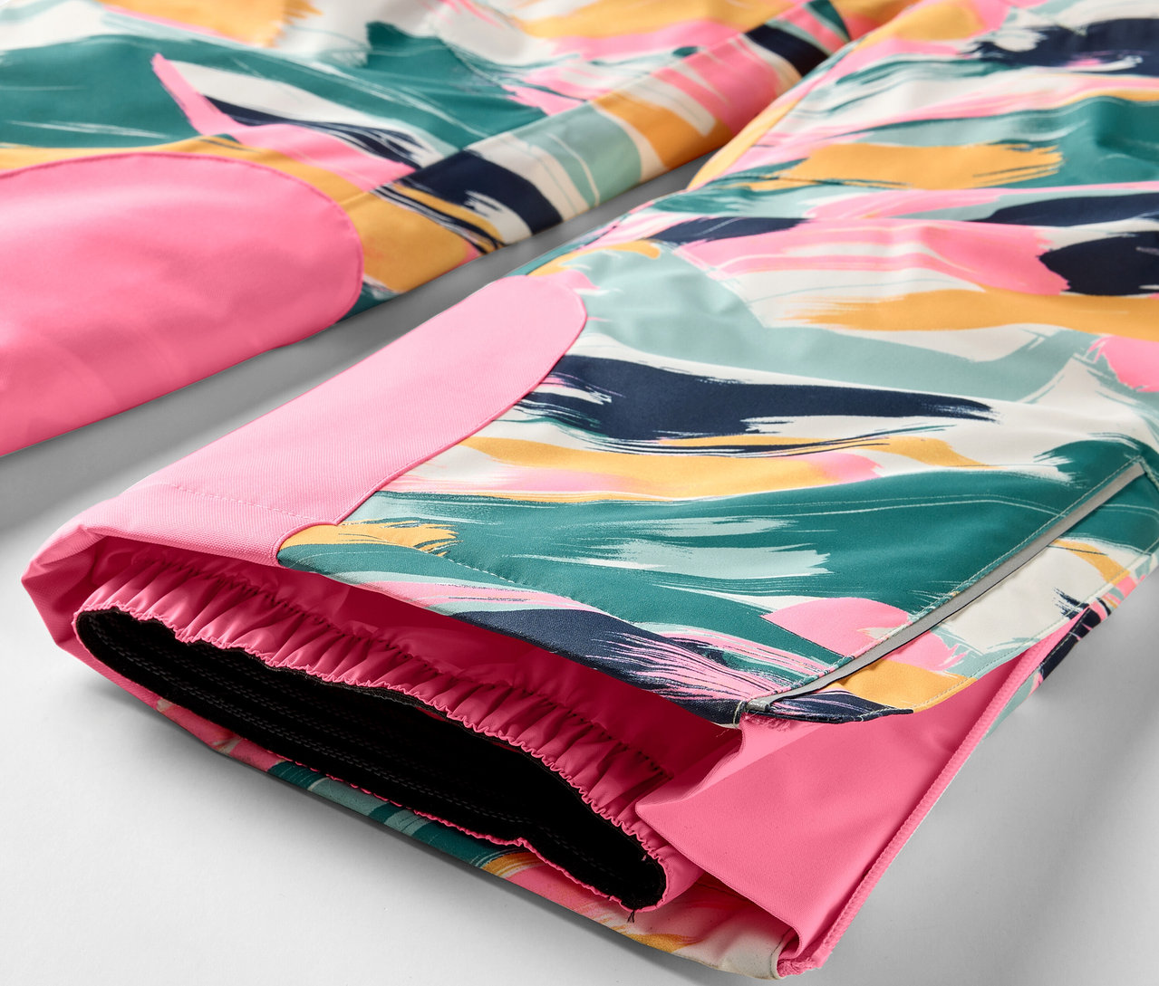 Detail einer bunten Hose mit pinkfarbenen Details.