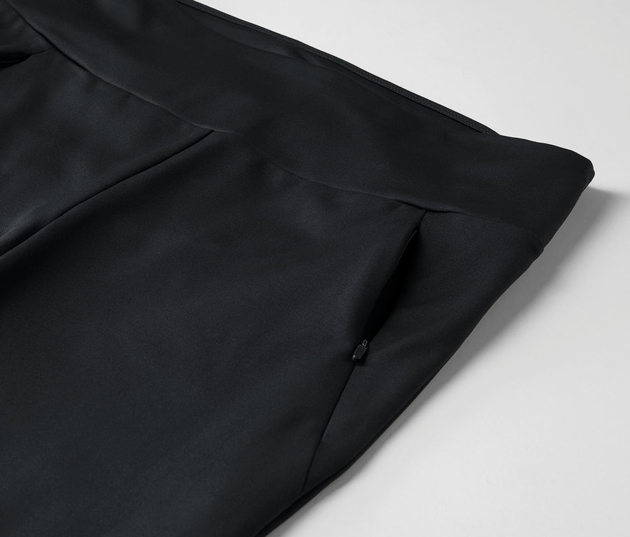 Detail einer schwarzen Hose mit Reißverschlusstasche.