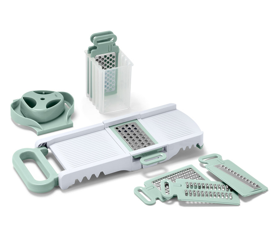 Ein Set von Küchenschneidern und -reiben mit weißem Körper und hellgrünen Details.