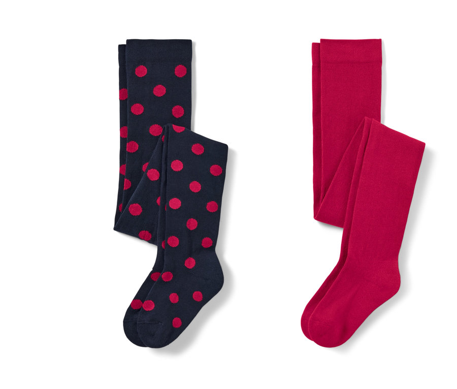 Zwei Kleinkind-Strumpfhosen: eine dunkelblaue mit roten Punkten und eine rote.