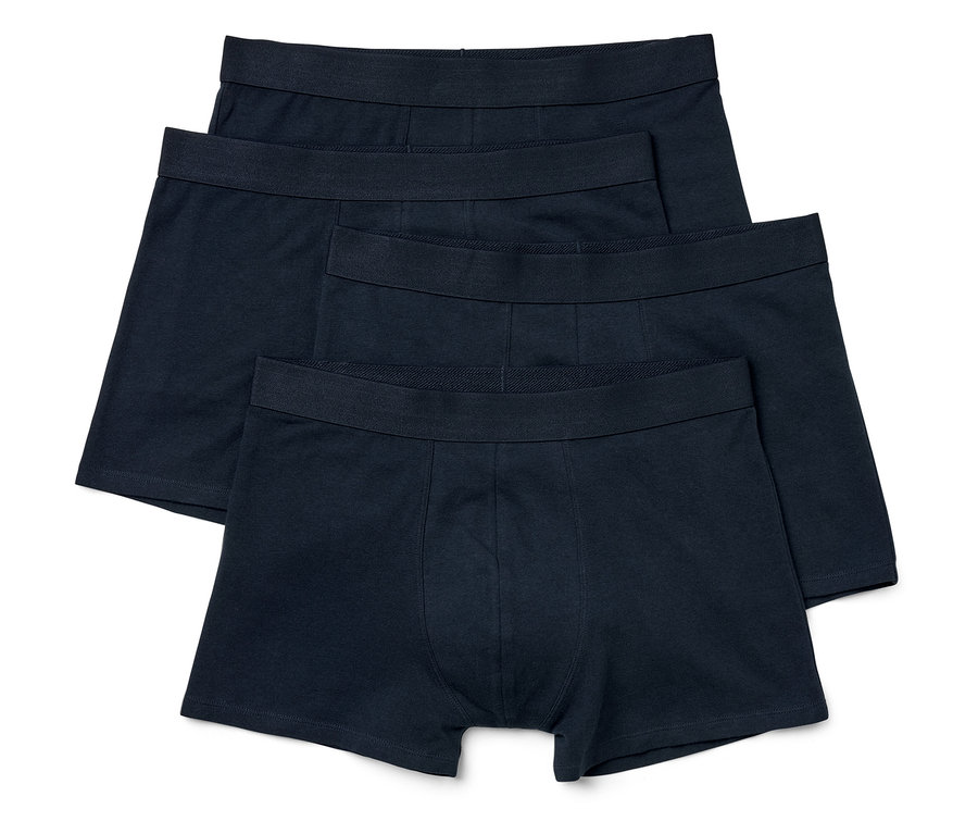 Vier schwarze Herren Boxershorts liegen übereinander.